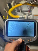 Atlanta HVAC Heat Furnace Repair 30338 Dunwoody by The Air Company of GA.  Inspection camera showing inside a metal pipe with surrounding gas lines and equipment.