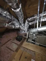 AC Cooling Dehumidification System Installation in Atlanta 30307 by The Air Company of GA. Insulated HVAC ductwork and furnace system installed in a wooden attic space with pink insulation.