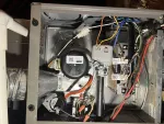 Furnace Heating Repair in Alpharetta 30009 by The Air Company of GA.  Interior of a gas furnace showing wiring, pipes, and control components with labels and connectors.