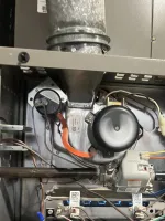 Heating Furnace Repair in Alpharetta 30009 by The Air Company of GA.  Inside view of a gas furnace showing blower fan, gas valve, wiring, and metal duct connections.