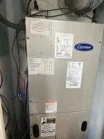 HVAC Repair in Sandy Springs 30328 by The Air Company of GA.  Indoor Carrier HVAC unit with wiring, pipes, labels, and control panels installed in a utility space.