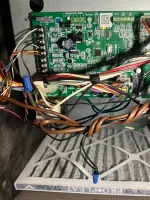 AC Repair and Maintenance in Alpharetta 30005 by The Air Company of GA. Inside view of HVAC unit showing circuit board, tangled wires, and air filter with warning label.