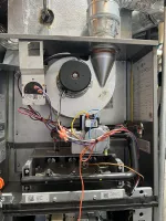 Residential Heating and Furnace Repair in Atlanta Decatur 30033 by The Air Company of GA.  Interior view of a gas furnace showing blower motor, wires, burners, and ventilation duct connections.