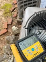 AC Repair and Maintenance in Alpharetta 30005 by The Air Company of GA. Close-up of HVAC digital manifold gauge measuring pressure and temperature on an outdoor air conditioning unit.