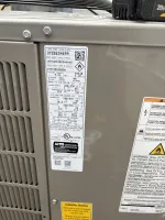 AC Heating Unit Installation in Atlanta 30306 by The Air Company of GA. Label on HVAC unit showing serial number, refrigerant type, operational parameters, and safety warnings.