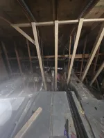 Commercial HVAC Repair in Atlanta 30306 by The Air Company of GA.  Attic space with exposed wooden beams, HVAC ducts, insulation, and mechanical equipment under the roof structure.