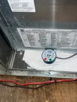Furnace Heating Repair in Atlanta Decatur 30030 by The Air Company of GA.  White Honeywell safety sensor attached inside metal HVAC unit with wiring and cloth nearby on wooden floor.