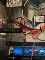 Residential HVAC AC Heating Repair Atlanta Brookhaven 30319 by The Air Company of GA.  Interior view of a furnace showing blue gas flames, wiring, and control components inside the metal casing.