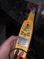 Commercial HVAC Repair in Atlanta 30324 by The Air Company of GA.  Yellow digital clamp meter measuring 12.90 amps on electrical wiring in a dark enclosure.