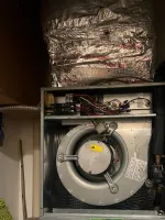 Heating Furnace Repair in Sandy Springs 30350 by The Air Company of GA.  Open HVAC unit showing internal blower motor, wiring, insulated ducting, and air filter in residential setting