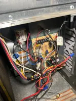 Residential Heating Furnace Repair in Norcross Atlanta 30071 by The Air Company of GA.  Inside view of an open furnace showing a circuit board and colorful electrical wiring connections.