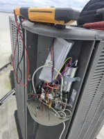 Commercial HVAC Repair in Atlanta Decatur 30317 by The Air Company of GA.  Open HVAC unit showing internal wiring, circuit board, capacitor, and a multimeter on top with connected test leads.