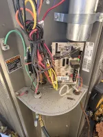Residential AC Heat Repair in Marietta 30068 by The Air Company of GA.  Inside view of a circuit board with colorful electrical wires in a metal enclosure warning of electric shock hazards.
