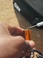 Furnace Heating Repair in Atlanta Decatur 30030 by The Air Company of GA.  Hand holding small copper cylinder keychain with keys and a black bag in soft background on wooden surface.