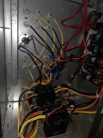 HVAC Heating Repair in Sandy Springs Atlanta 30328 by The Air Company of GA.  Electrical panel with multiple colored wires connected to circuit breakers and fuses inside a metal enclosure.