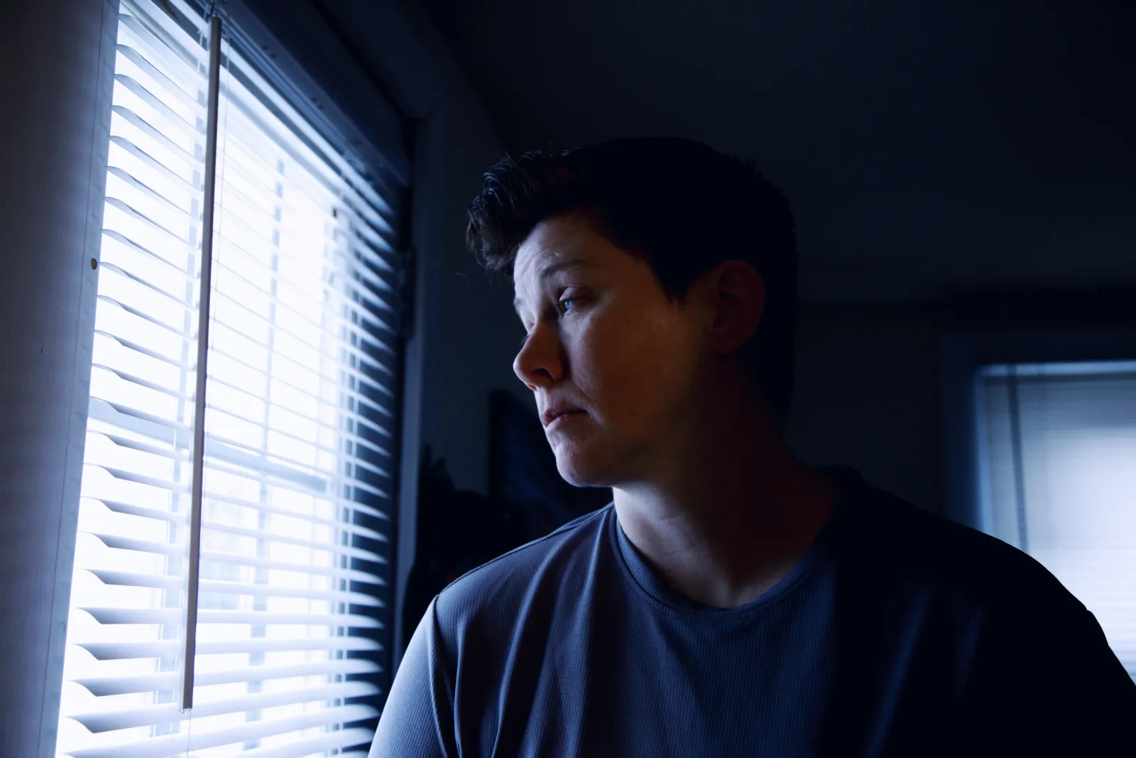 grieving woman looking out window