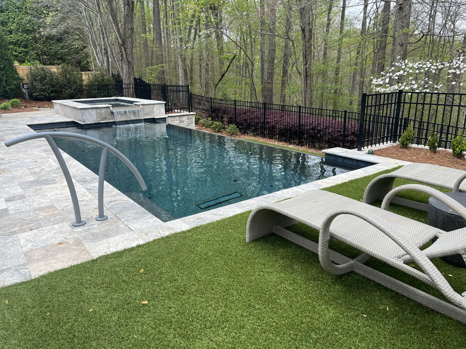 pool with hardscape and hot tub