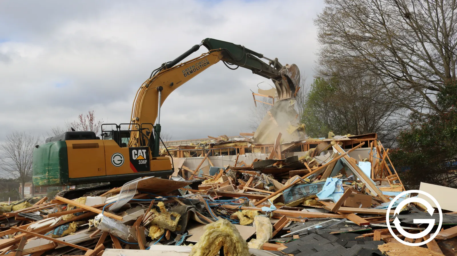 Excavator tearing down office building