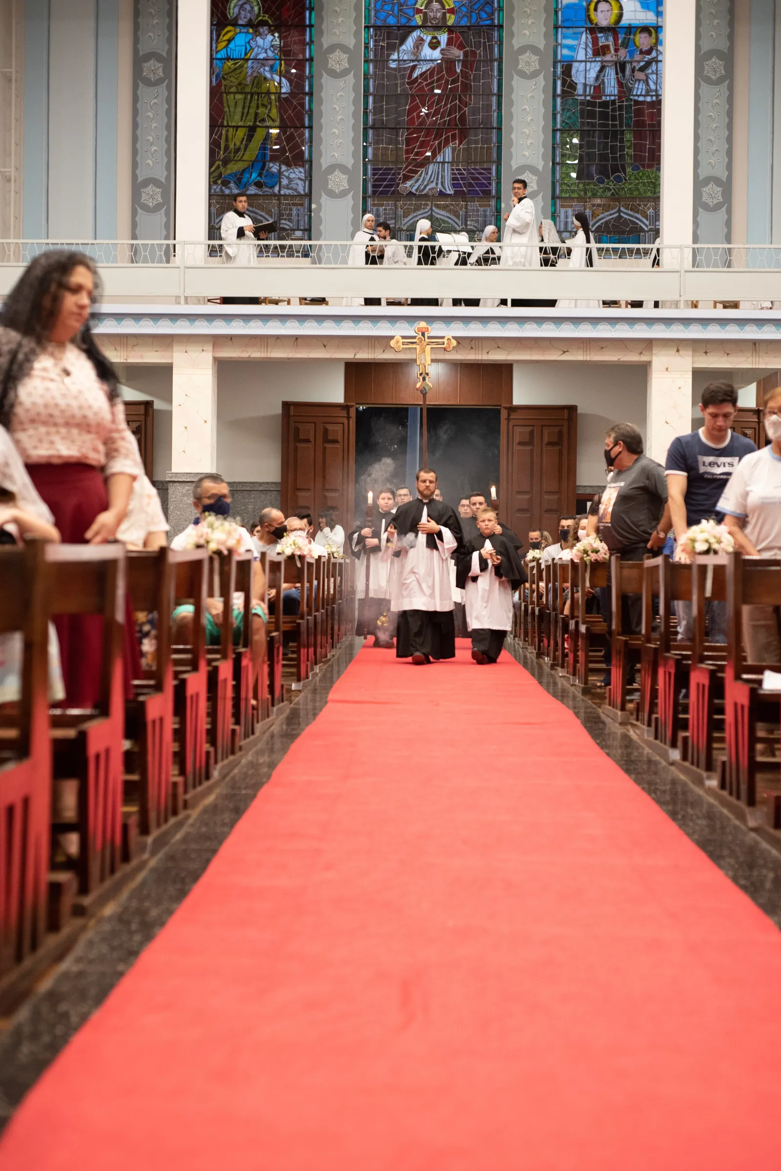 a group of people sitting at catholic mass