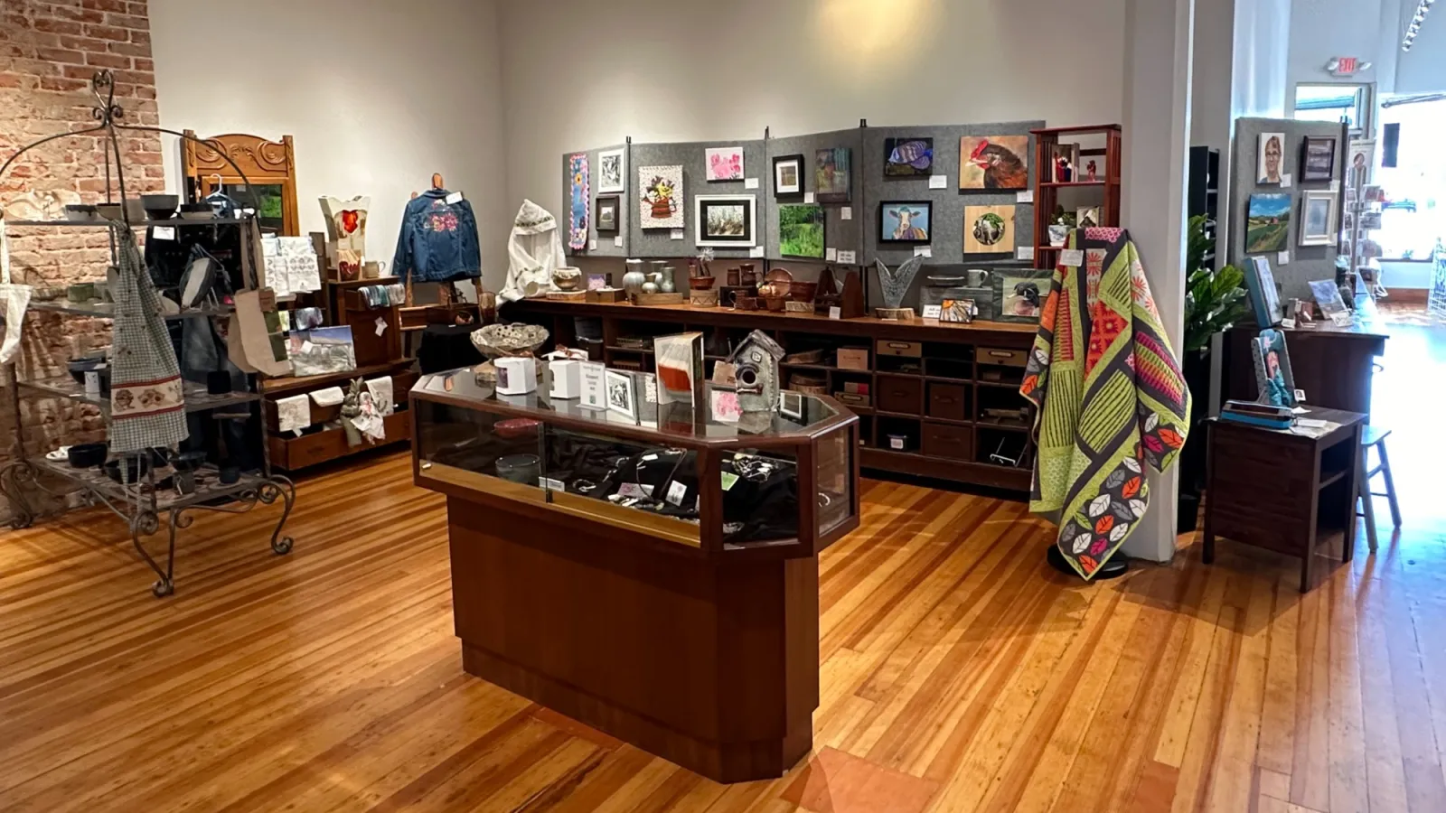 a room with a wood floor and a wood floor with a display of objects on it