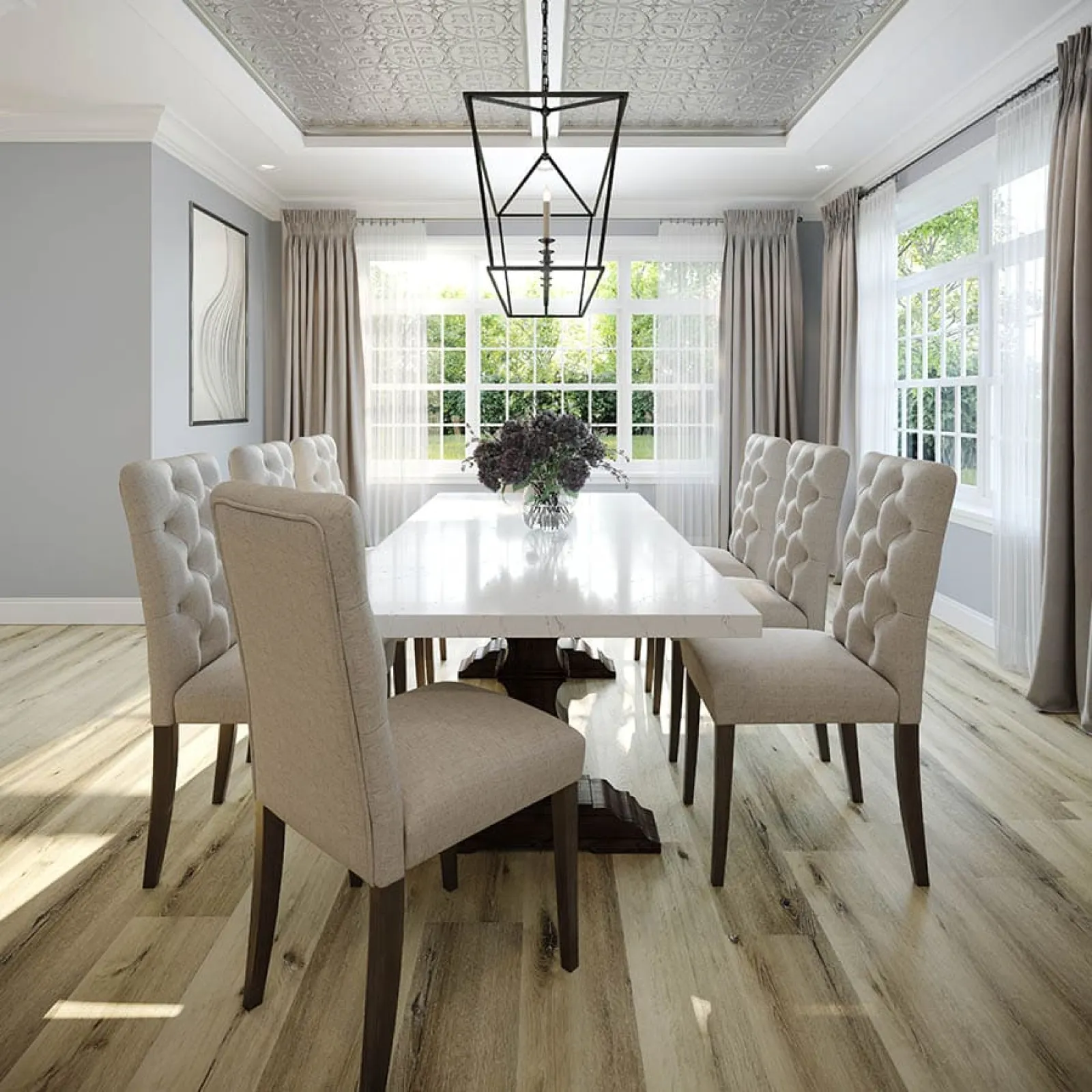 Bright modern dining room with tufted beige chairs, white table, large windows, wood floor, and geometric pendant light