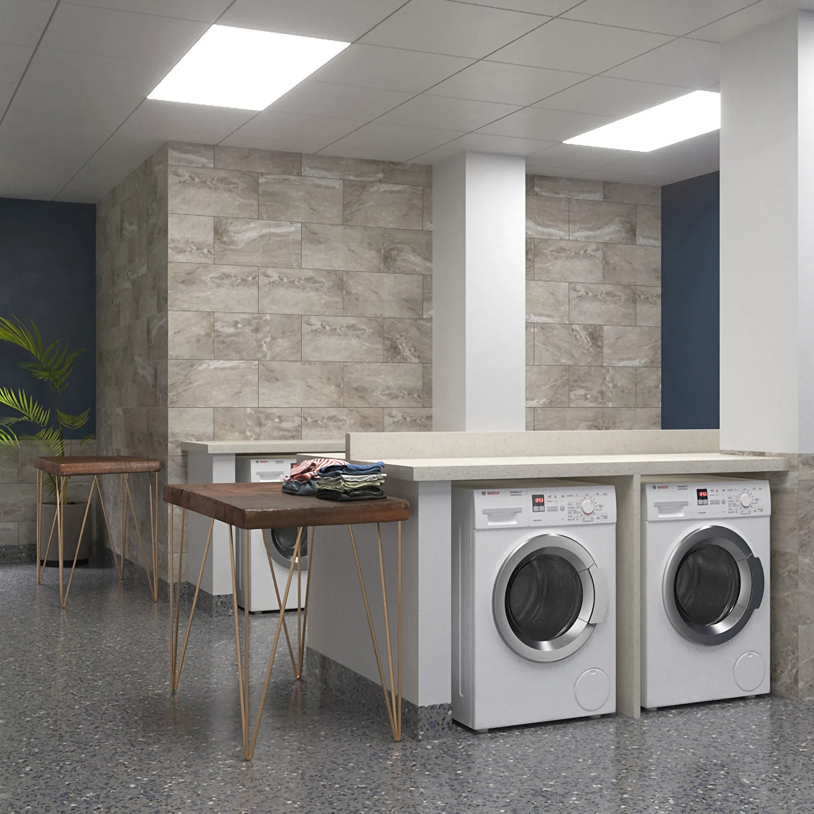 Modern laundry room with front-load washers, stone tile walls, wooden folding tables, and bright overhead lighting
