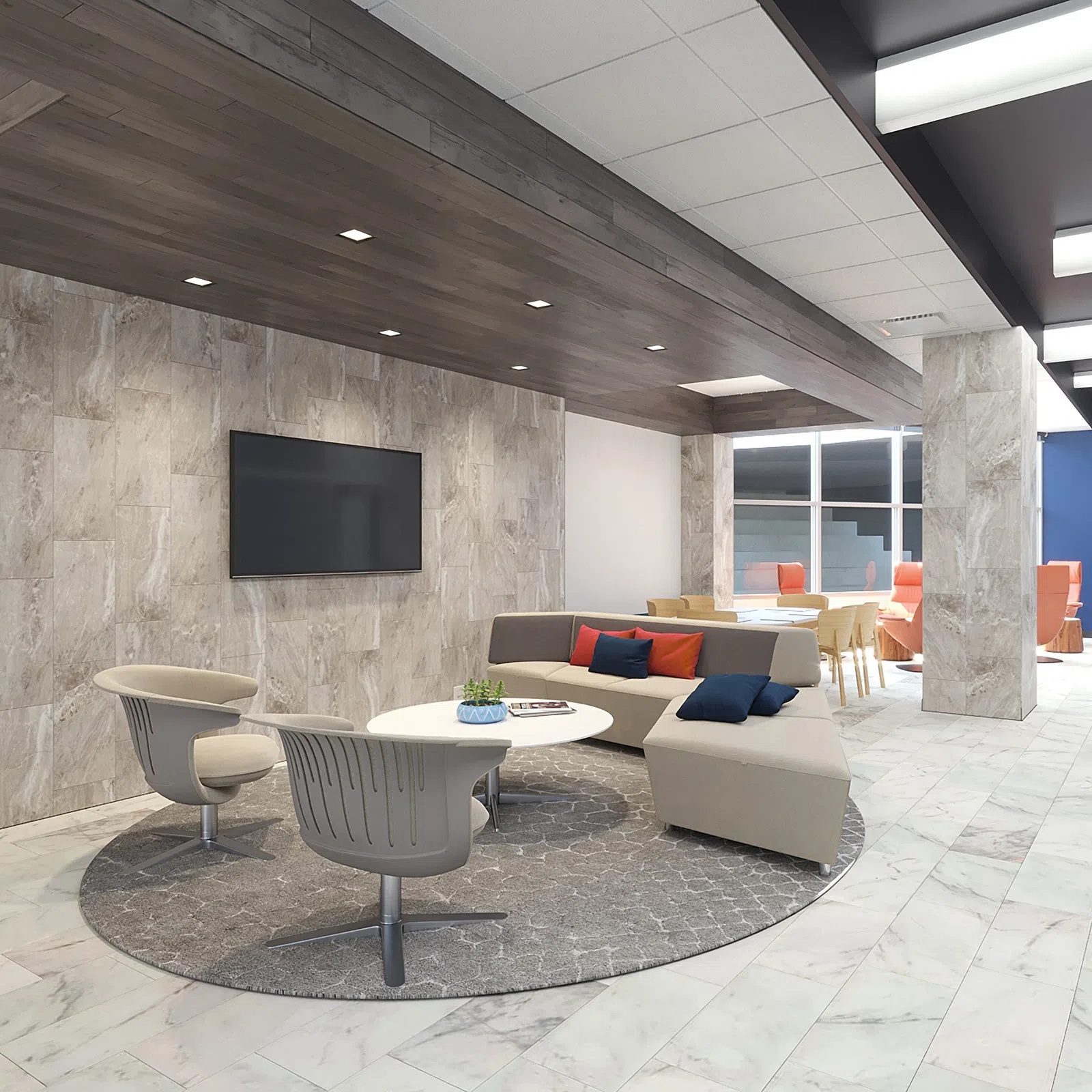 Modern office lounge with beige sectional sofa, gray chairs, round table, and wall-mounted TV on tiled wall.