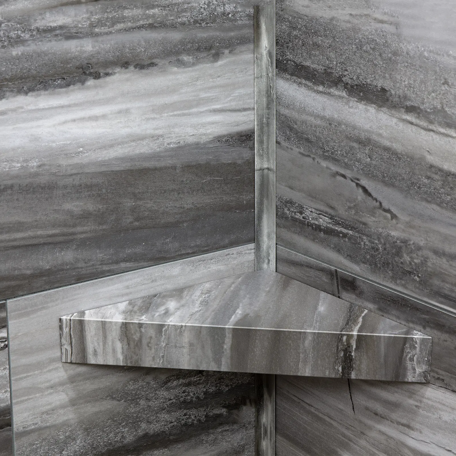 Gray marble corner shelf mounted on matching marble walls with natural stone patterns.