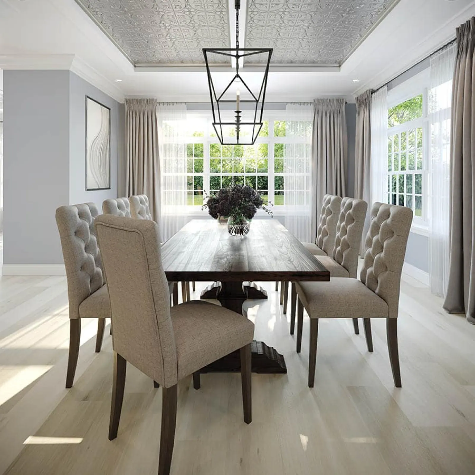 Modern dining room with tufted beige chairs, dark wood table, large windows, and decorative ceiling light fixture