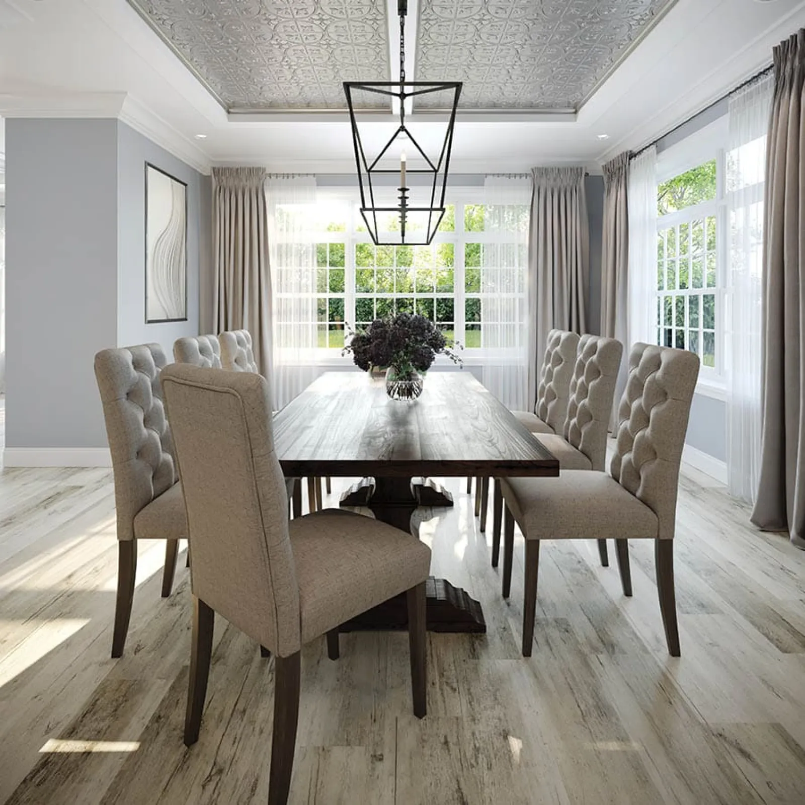 Bright dining room with a wooden table, eight tufted beige chairs, large windows, and a geometric chandelier.
