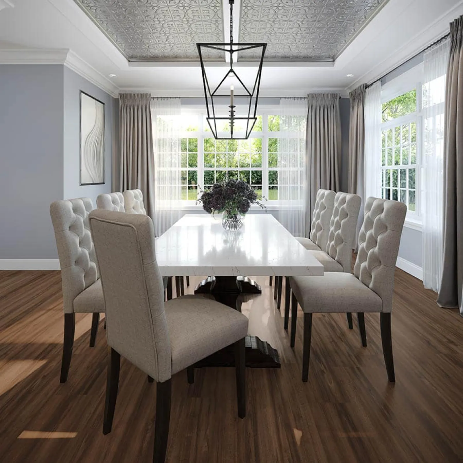 Bright dining room with white table, tufted beige chairs, wood floor, large windows, and decorative ceiling light fixture
