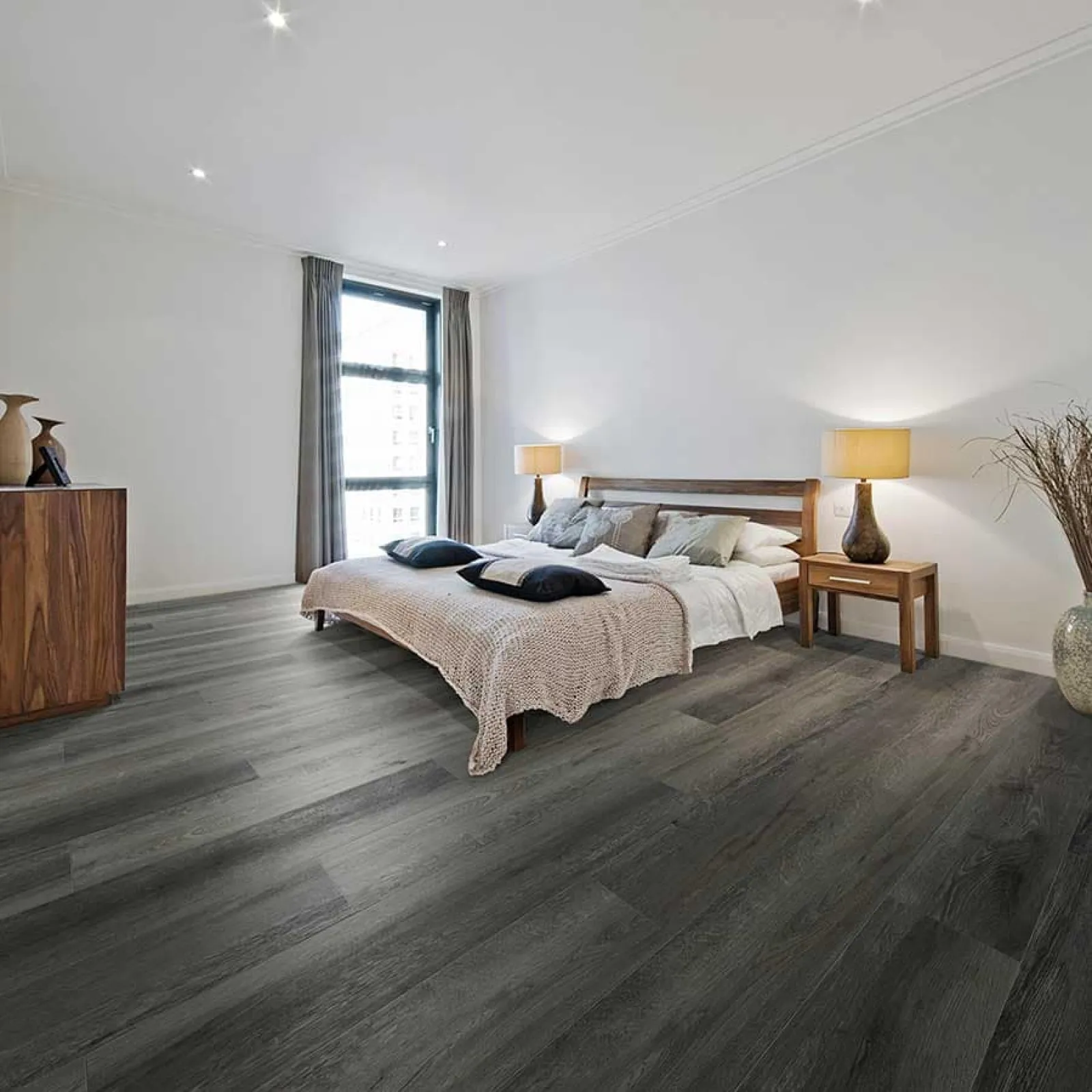 Modern bedroom with dark wood flooring, neutral bedding, wooden furniture, floor-to-ceiling window, and bedside lamps