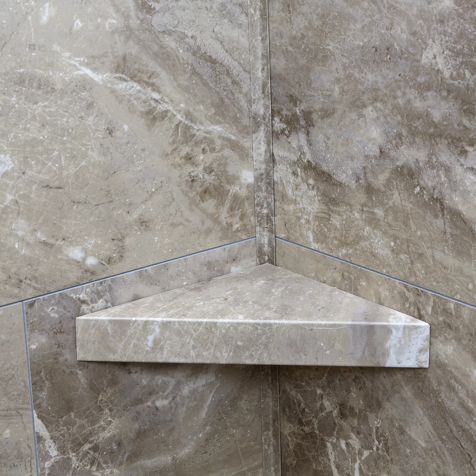 Corner marble shower shelf with beige and brown natural stone texture and polished finish.