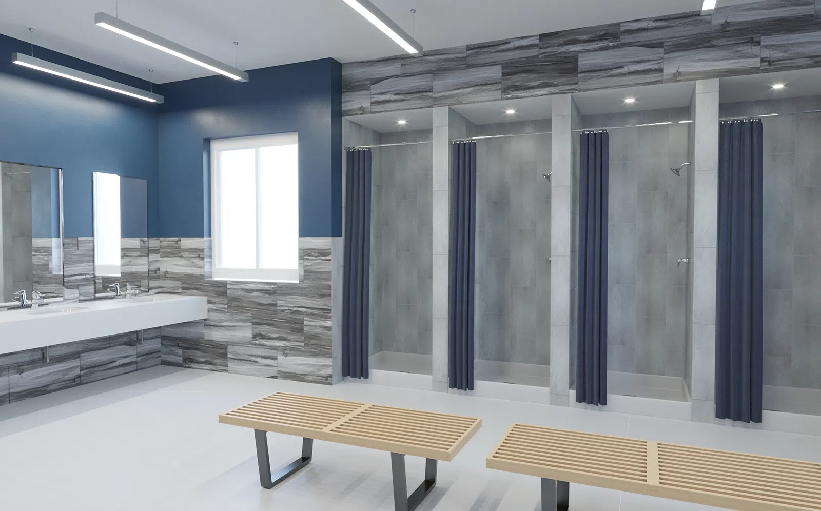 Modern locker room with blue and gray tile walls, wooden benches, sinks, mirrors, and shower stalls with navy curtains.