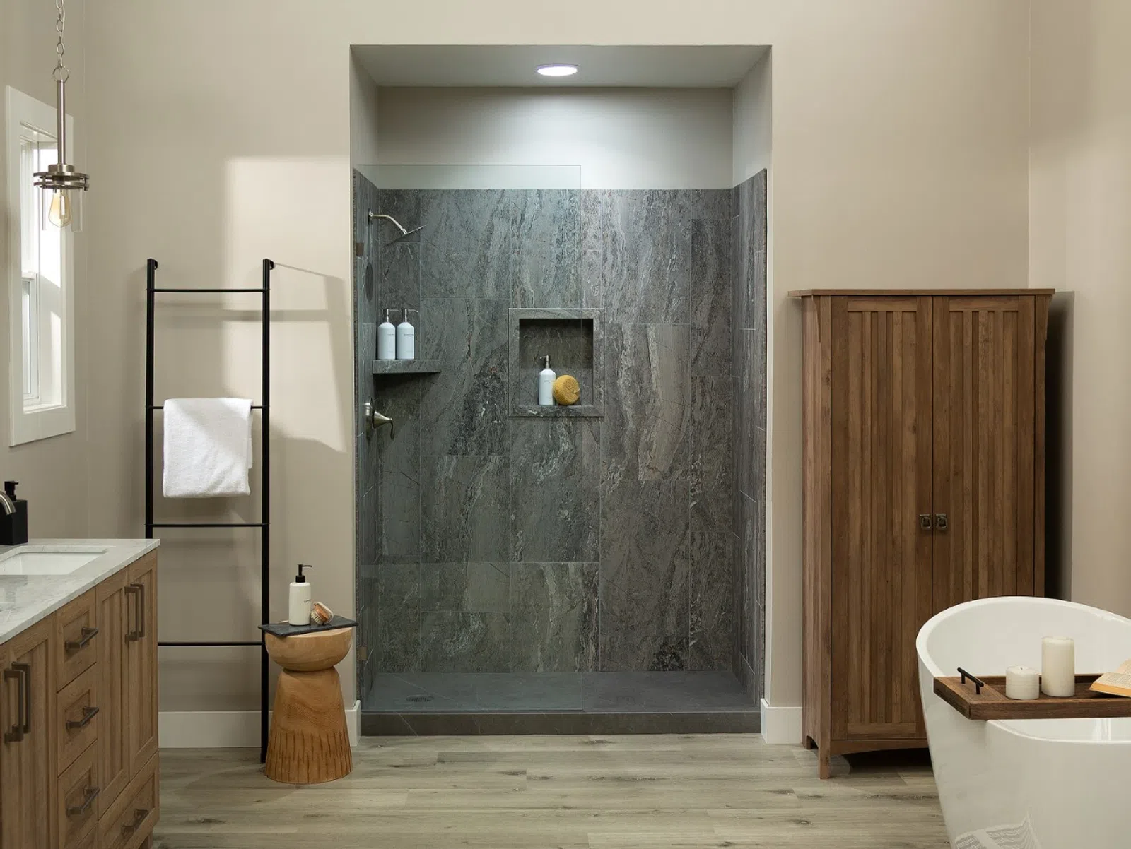 Modern bathroom with wood vanity, freestanding tub, walk-in shower, wooden cabinet, and neutral decor.