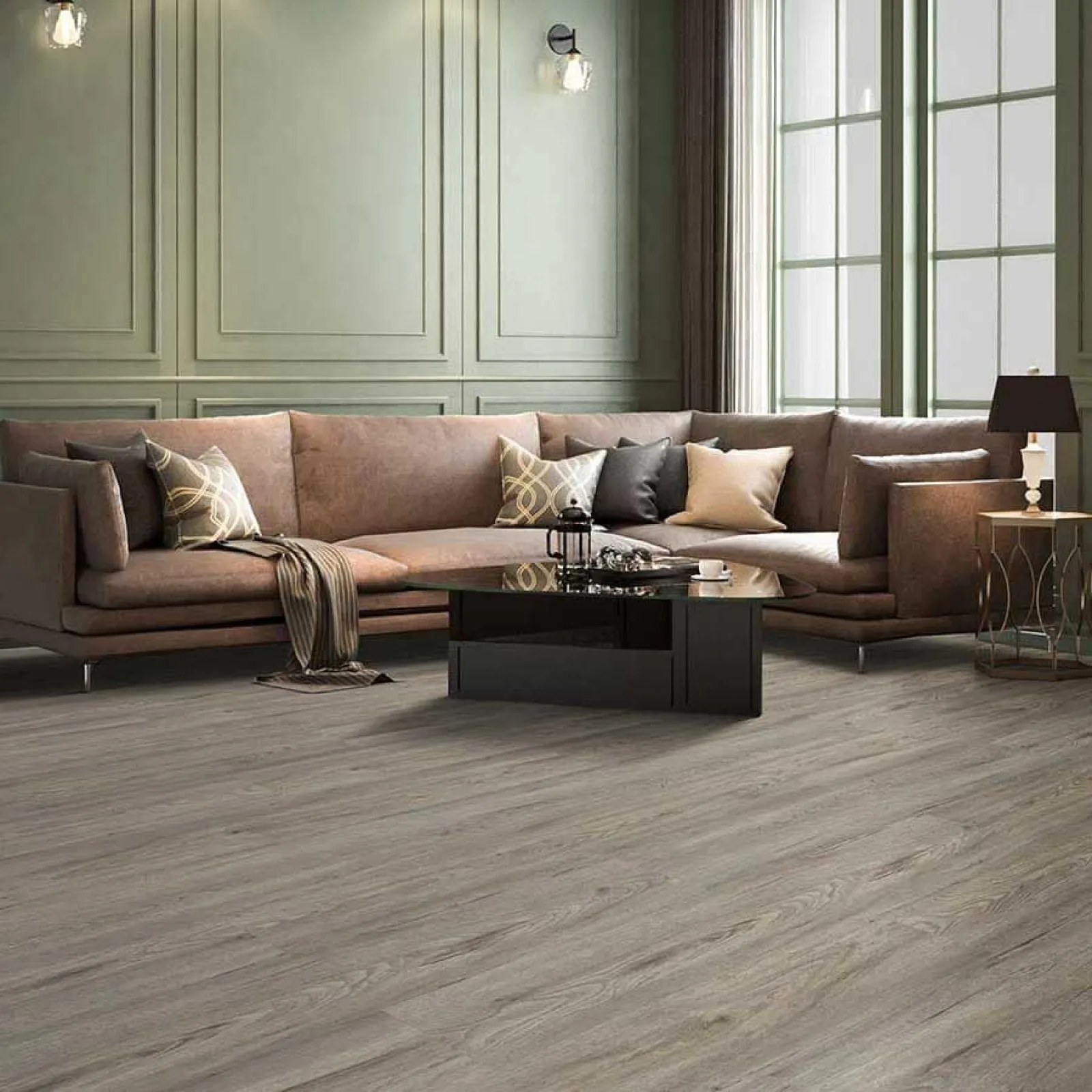 Modern living room with L-shaped brown sofa, glass coffee table, wooden flooring, and large windows with natural light.