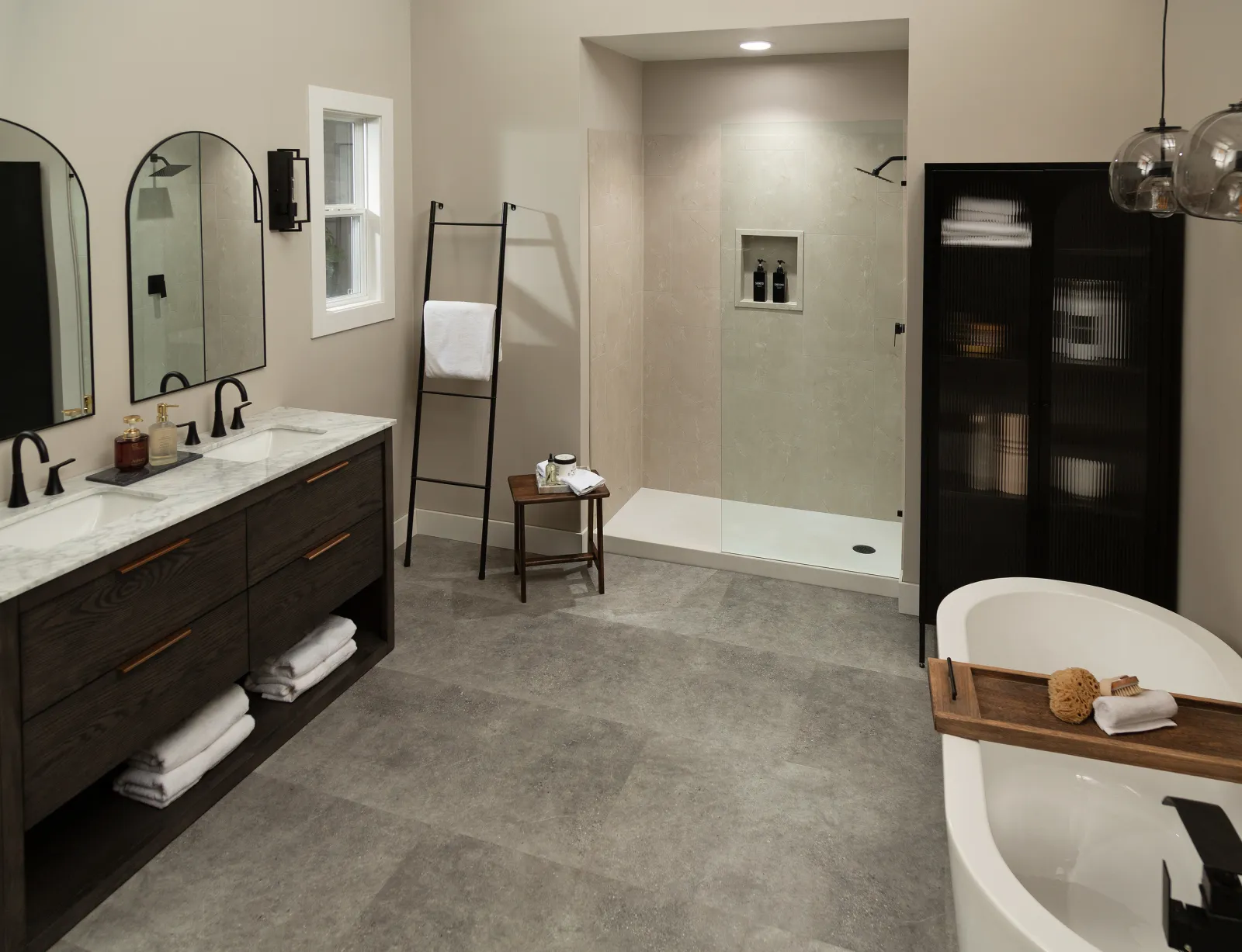 Modern bathroom with double vanity, walk-in shower, freestanding tub, and neutral tones with sleek finishes