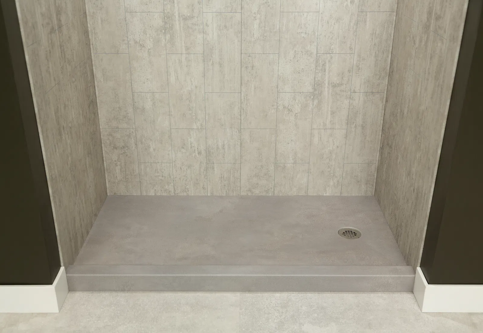 Empty walk-in shower with beige stone tile walls and gray floor with central drain on raised platform.