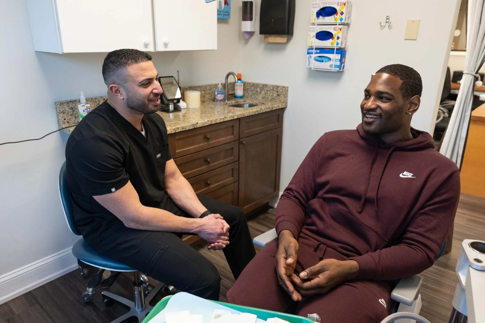 Healthcare professional talking with patient in a modern medical office during consultation.