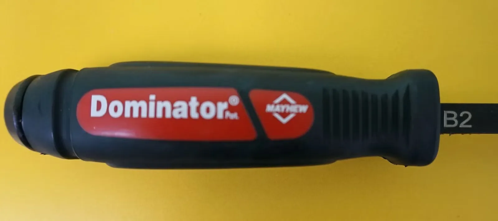 Close-up of Mayhew Dominator ratchet screwdriver handle on a yellow background.
