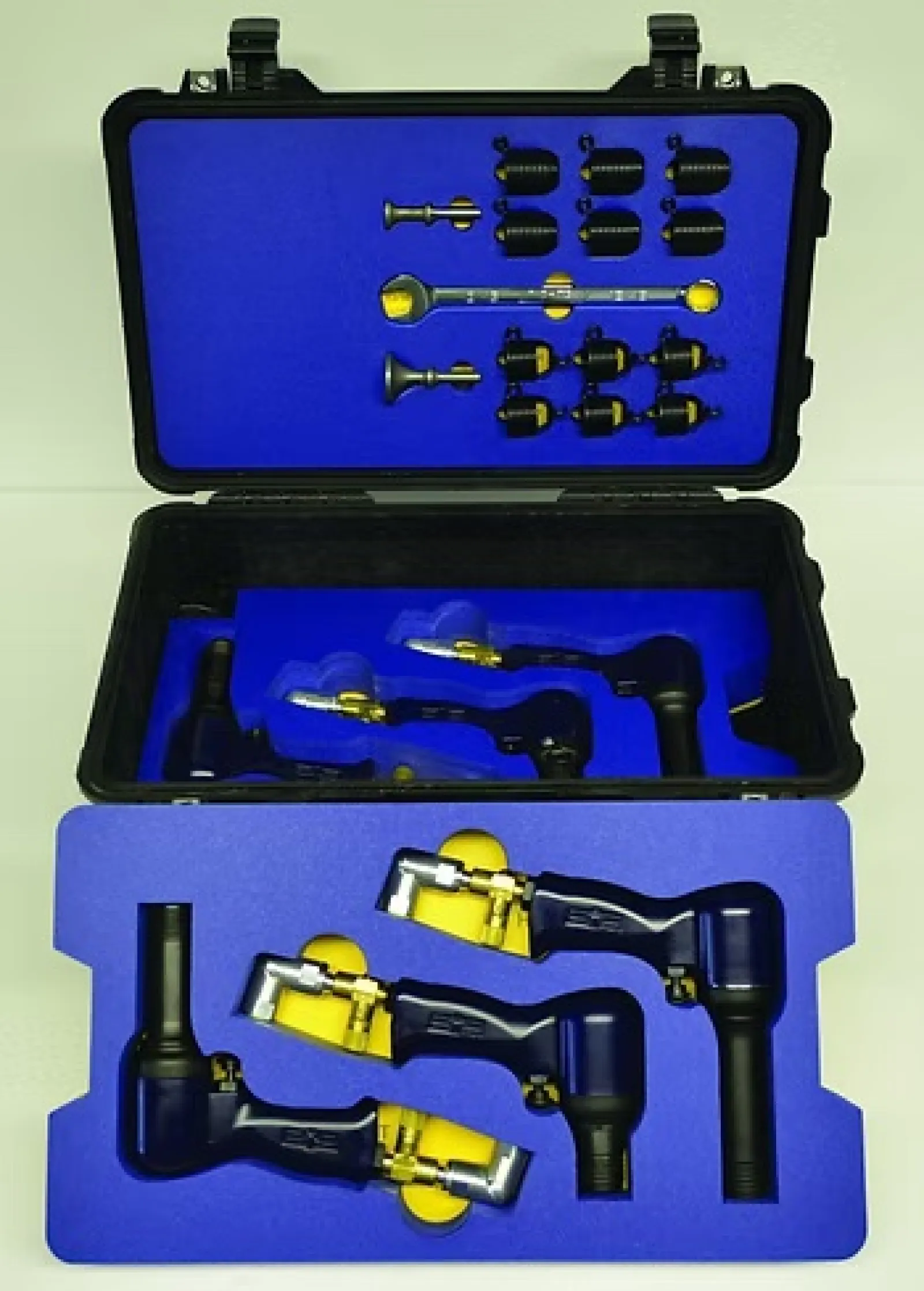 Open black case with blue foam inserts holding multiple pneumatic tools and metal fittings.