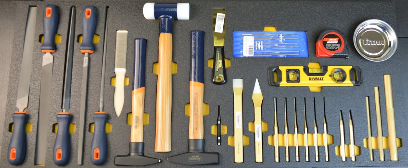 Set of woodworking and measuring tools including chisels, hammers, files, tape measure, level, and magnetic parts tray.