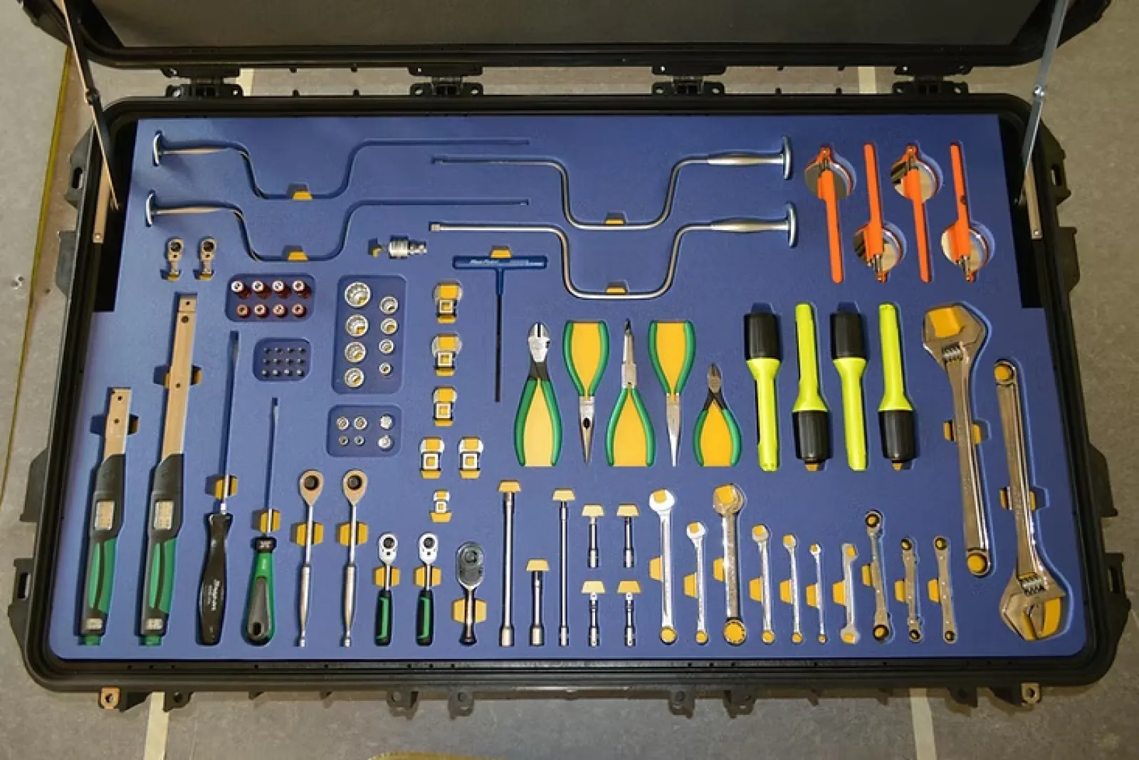 Organized tool case with various hand tools including pliers, screwdrivers, wrenches, and specialized metal tools.