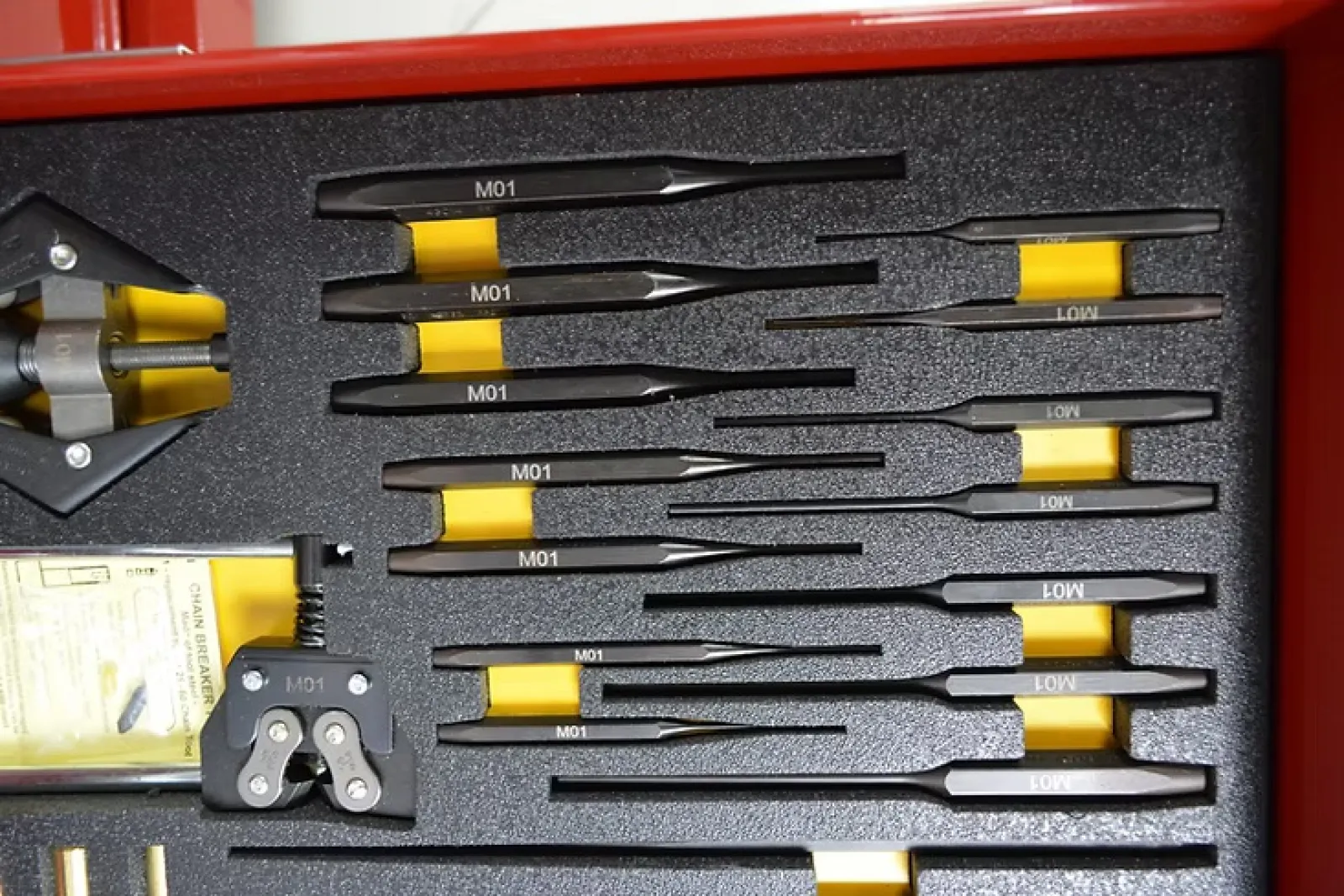 Set of precision screwdrivers and tools neatly arranged in a red toolbox foam insert