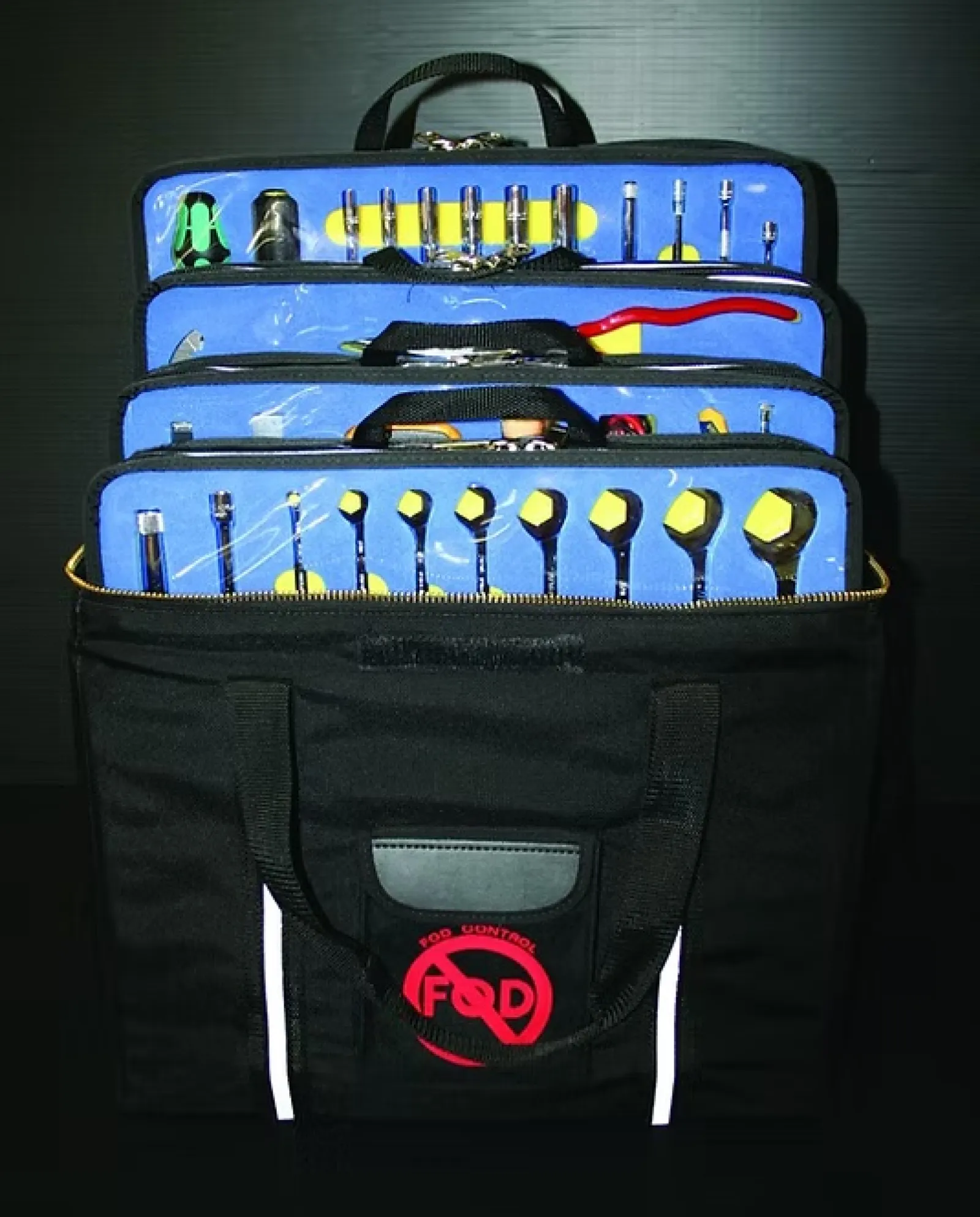 Portable black tool bag with organized blue inserts holding various hand tools against a dark background