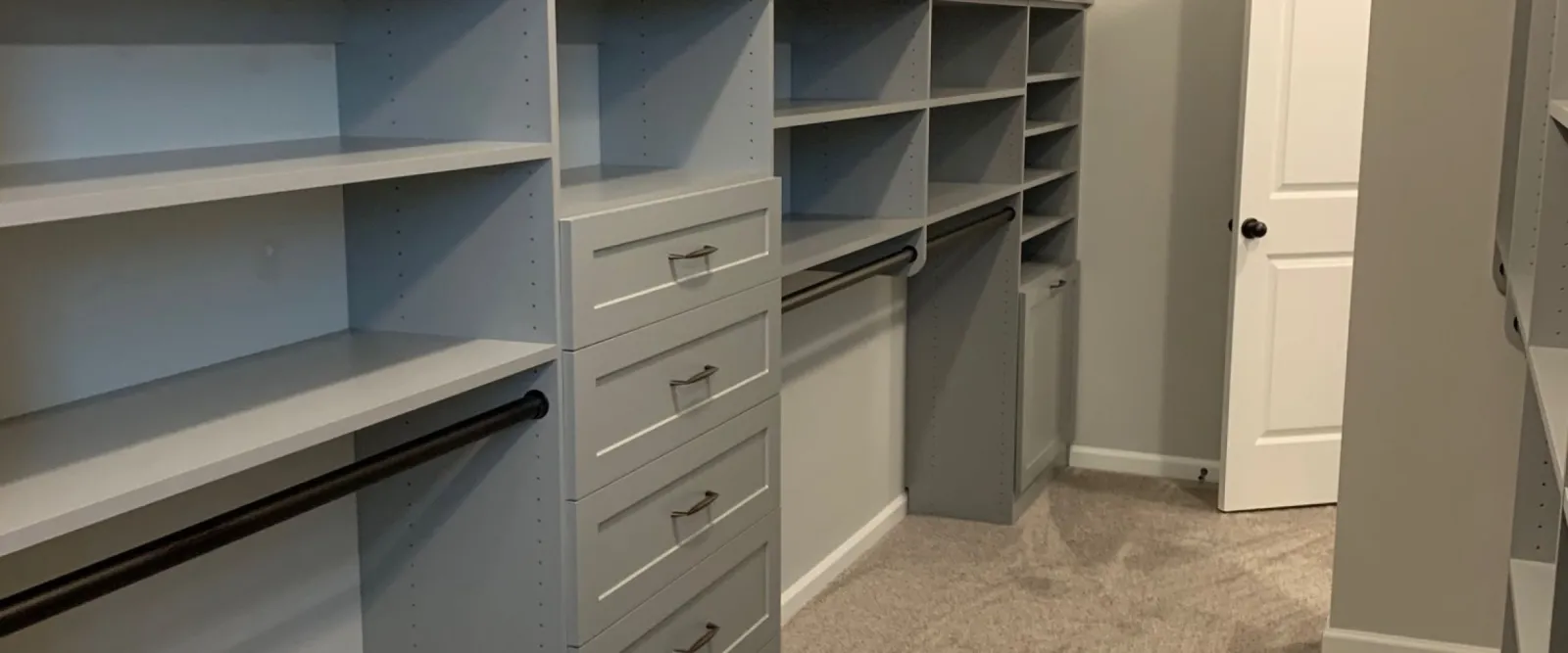 Gray storage system in a large walk-in closet