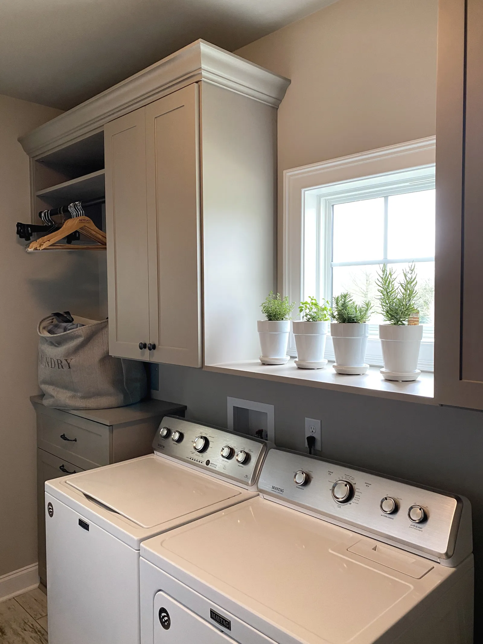 Laundry room with custom cabinets and laundry hamper