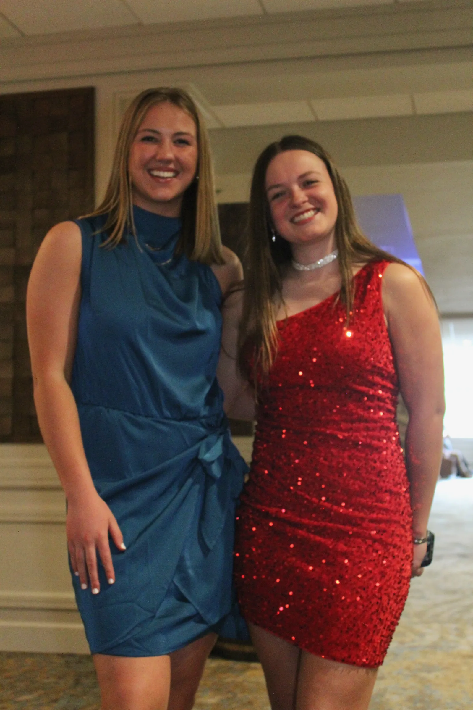two women wearing dresses