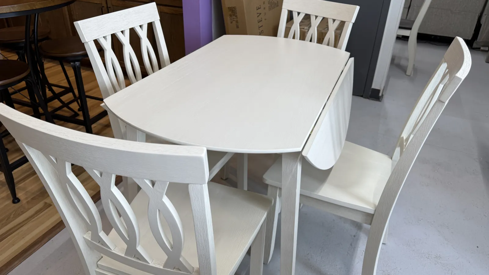 a white table with chairs around it