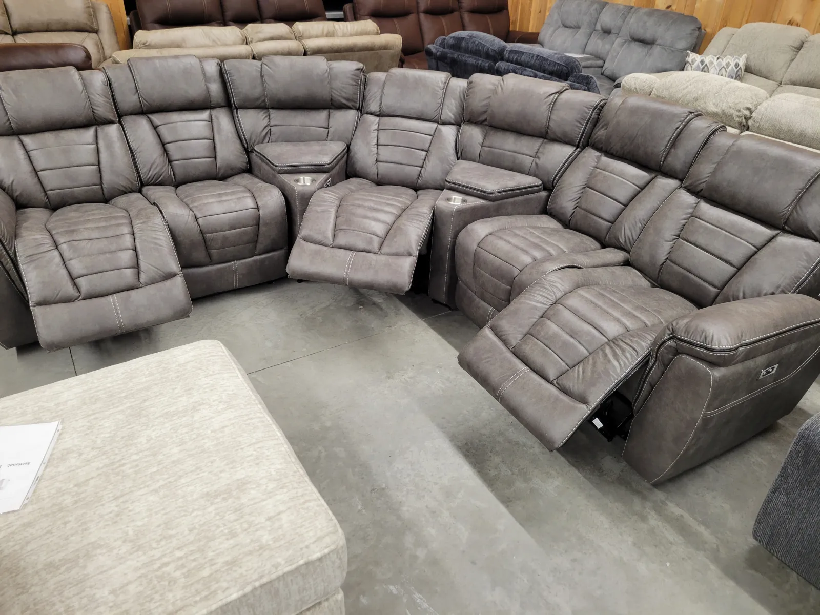 a group of grey leather couches